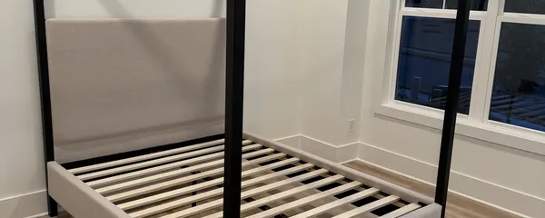 Black four-poster bed frame assembled