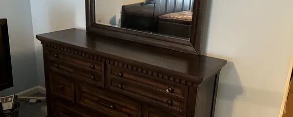 Dresser and mirror assembled in a bedroom