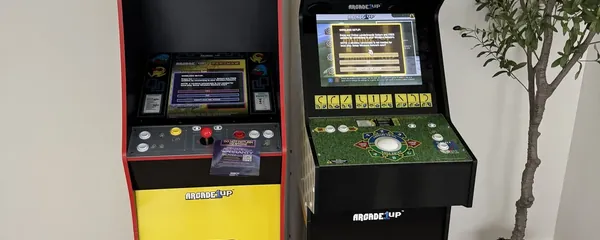 Two arcade cabinets set up in a games room