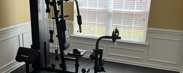 Cable machine and rack built in a finished basement gym