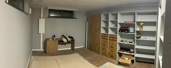 Closet shelving being fitted in a basement