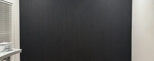 Dark slat accent wall installed