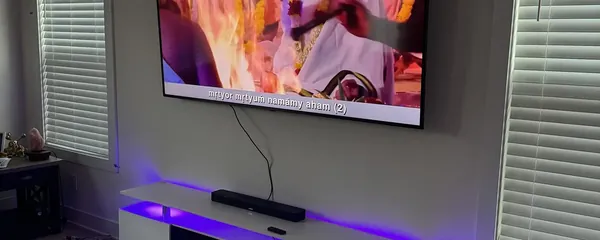 Television mounted above a lit media console
