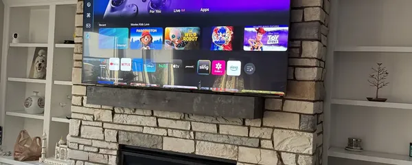 Television mounted on a stone chimney breast