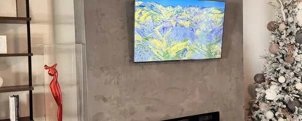 Television mounted on a plaster fireplace wall