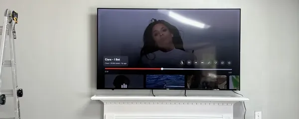 Television mounted above a painted mantel